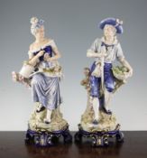 A pair of large Continental porcelain figures of gardeners, late 19th century, he holding a spade