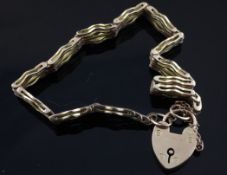 An Edwardian 15ct gold gate link bracelet, with heart shaped padlock, 18 grams.