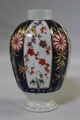 A Worcester kakiemon pattern fluted ovoid tea caddy, c.1770, decorated with alternating panels of