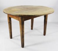 A French Provincial fruitwood oval drop leaf dining table on square section supports, extended 3ft