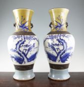 A pair of Chinese blue and white crackle glaze vases, painted with birds amid prunus, with brown