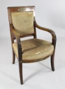A 19th century French Empire mahogany open armchair, with gilt brass mounts, shaped over stuffed