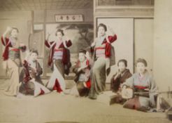 A Japanese red and gold lacquered album of photographs, containing fifty tinted images of Japanese