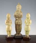 Three pale green glazed pottery figures of soldiers, probably Tang dynasty, each modelled in