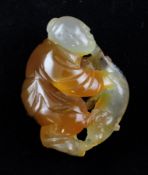 A Chinese agate carving of a boy grasping a cat, 18th / 19th century, the carver using the russet