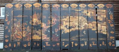 A late 19th / early 20th century Chinese twelve panel coromandel screen, polychrome lacquered with a