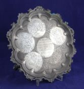 A Victorian silver salver, of shaped circular form, with pierced scroll border and engraved