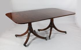 A William Tillman Georgian style mahogany twin pillar dining table, with rounded rectangular top and