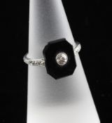 A 1920`s/1930`s platinum, black onyx and diamond set octagonal tablet ring, with diamond set