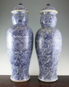 A pair of large blue and white baluster vases and covers, Kangxi style, painted with repeating