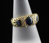A Victorian style 18ct gold sapphire and diamond half hoop ring, with engraved shoulders and set
