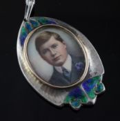 An Edwardian Arts & Crafts silver and enamel pendant with inset miniature portrait of a boy, Spencer