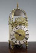 A Charles II and later brass lantern clock, with silvered Roman dial and central engraved panel of