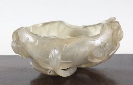 A Chinese agate `lotus leaf` brushwasher, in the form of a curled leaf, carved in relief and