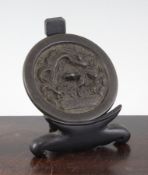 An early Ming bronze circular mirror, Hongwu period, cast in relief with a dragon amid clouds and