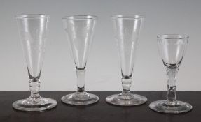 Three George III ale glasses and a small wine glass, late 18th century, comprising a pair of