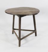 An early 19th century oak cricket table, with circular top, 2ft 5in.