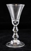 A George I double drop knop baluster glass, c.1720, with bell bowl and domed folded foot, 6.9in.