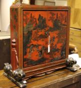 A 19th century red lacquer chinoiserie table top cabinet, fitted two doors, single base drawer and