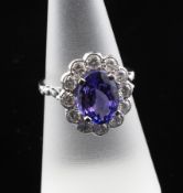 An 18ct white gold, tanzanite and diamond cluster ring, of oval form, size M.