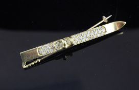 A late 1990`s novelty 18ct gold and diamond set brooch, modelled as a ski and ski pole, 2.25in.