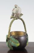 A late 19th century Austrian cold painted and patinated bronze basket, with a bird mounted rustic