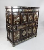 A late 19th century Chinese mother of pearl inset hardwood cabinet, fitted with an arrangement of