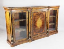 A Victorian burr walnut credenza, with central cupboard door between two glazed doors, with tapering