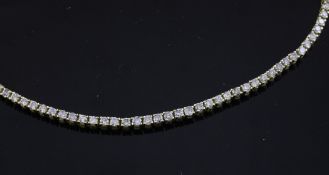 An 18ct gold and diamond line bracelet, set with sixty two stones, 6.75in.