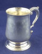 A George III silver mug, of plain baluster form, with acanthus leaf capped scroll handle, W.T.