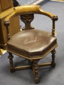 A late Victorian walnut tub chair, with hexagonal upholstered seat and lion carved arms