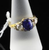 An early 20th century gold three stone sapphire and diamond set ring, set with oval cut sapphire