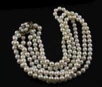 A triple strand cultured pearl choker necklace with 9ct gold , cultured pearl and garnet set