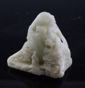 A Chinese creamy celadon jade scholars carving, carved in relief with a sage, on a rocky ledge