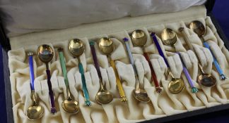 A cased set of twelve Norwegian silver gilt and polychrome enamel coffee spoons by David Andersen,