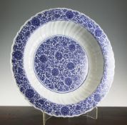 A Chinese Ming style blue and white `scrolling lotus` dish, Kangxi six character mark and possibly