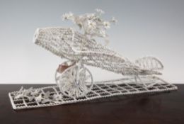 A 20th century French beadwork funeral stand, modelled as an aeroplane with flowers, 19in.