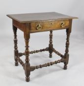 A late 17th century oak side table, with moulded top edge over a single drawer with axe drop