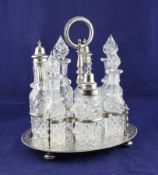 A Victorian silver oval cruet stand, with engraved decoration, ring handle on turned stem with seven