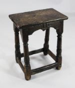 A 17th century oak joynt stool, the burred rectangular top over a shaped frieze, on baluster