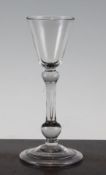 A balustroid wine glass, c.1735, with funnel bowl, shoulder knop and true baluster stem above a