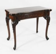 A Victorian Holland & Sons burr walnut games table, with folding top and concertina action, on