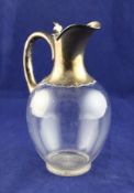 A late Victorian silver mounted plain glass claret jug, of baluster form, with clover shaped