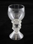 A George II roemer, c.1740-50, with angular bowl joining the hollow stem with ribbed collar and