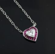 A 14ct white gold ruby and diamond heart shaped pendant necklace, with heart shaped diamond and ruby