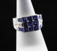 A stylish platinum, pave set sapphire dress ring, of square form with sapphire and diamond set