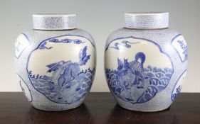 A pair of Chinese blue and white ovoid jars and covers, early 20th century, each painted with