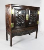 A 19th century Chinese hardwood cabinet, with two doors carved in relief with a fishing party in a