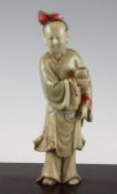 A Chinese soapstone standing figure of a man holding a cup, 18th / 19th century, with some