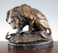 After Antoine Louis Barye. A bronze figure of a lion and a python, on naturalistic base with black